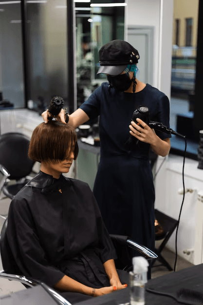 Stylist finishing a client's haircut